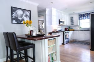 The kitchen—which shares a wall with the guest bedroom— was already updated when the Metzlers moved in, but they replaced the terra-cotta backsplash with subway tile to give it a sleeker look.