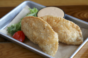 Start a meal with brisket-filled crispy empanadas.