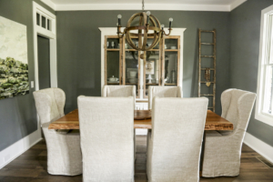 The atmospheric dining room features slipcovered-linen high-back chairs from Restoration Hardware, a felled-pecan wood dining table made by Shane’s company, WoodKith, and a wine barrel-stave chandelier by BoBo Intriguing Objects.