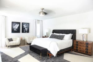 The master bedroom’s Nathan Anthony bed is flanked by JKM Home nightstands and alabaster lamps from Arteriors.
