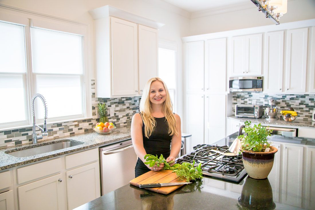 The author is pictured with her wood cutting board, which works well for chopping produce but not meat. PHOTO: Jamie Annarino