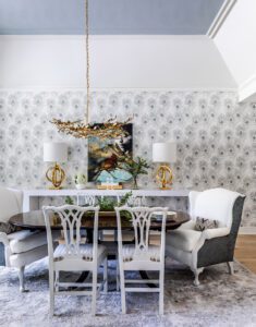 Done with peacock wallpaper and heirloom repurposed and reupholstered wing chairs, the dining room combines the new and old.