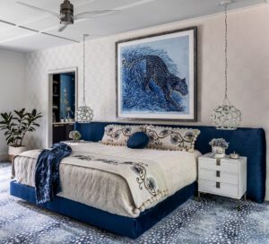 A framed Hermès scarf inspired the blue tones and animal print carpet in the primary bedroom.