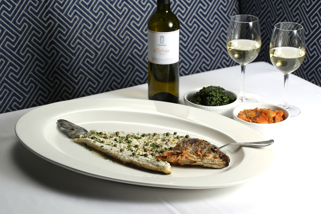 Whole roasted fish is one of the signature experiences of Kyma. To go with it: Kale and a stew of giant white beans and tomatoes.