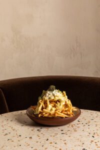 A tower of french fries, topped with crème fraiche, béarnaise, caviar and chives is more than enough to share.