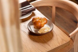 Light-as-air milk buns with whipped butter infused with togarashi are a must-order.