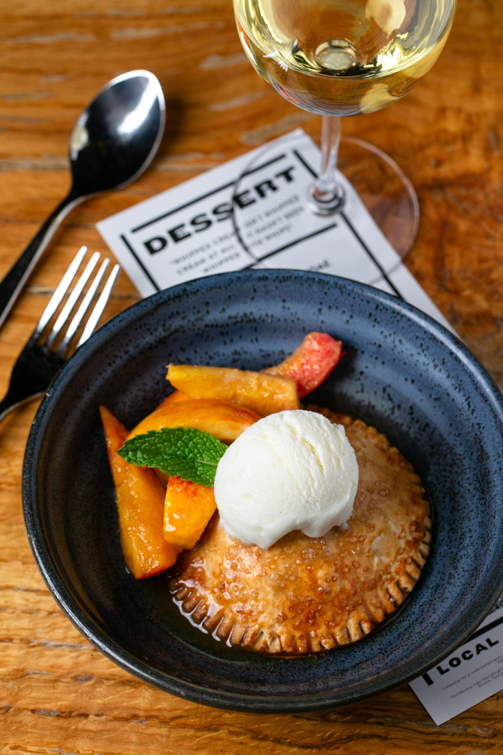 Don’t skip desserts like peach hand pie with vanilla ice cream at Local Three.