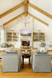 Wooden beams stained to mirror the floors accentuate the towering ceiling while drawing the eye completely around the family room.