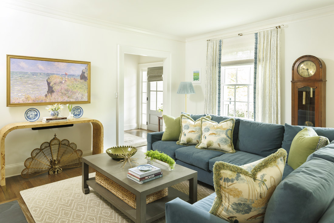 Blues, greens and neutrals combine in the living room, where handpicked throw pillows dress up the sectional sofa.