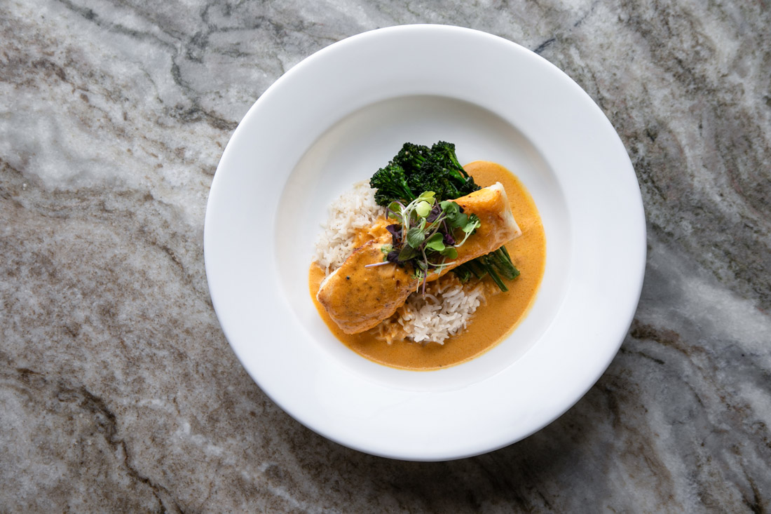 Halibut comes dressed with sweet-spicy red butter curry, charred broccolini and coconut rice.