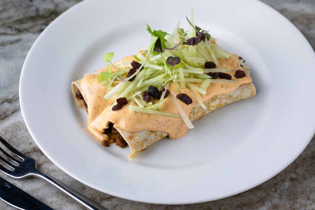 Bobotie crepes, a traditional South African dish, offer sweet and savory flavors.