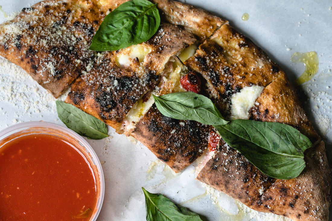 The Vesuvio calzone at Antico Pizza Napoletana packs a punch with spicy and salty flavors; temper that heat with the tangy marinara sauce served alongside.
