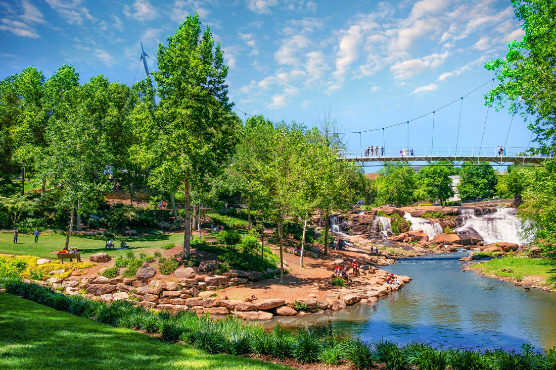 A pedestrian bridge over the Reedy Falls gives outdoor enthusists a pastoral view.