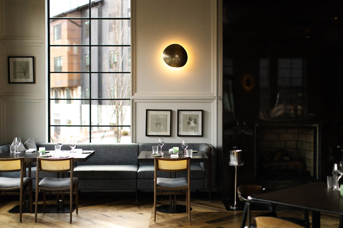 The dining room at January is done in Sossego dining chairs, hand-blown glass fixtures by Bomma and custom-designed furnishings.