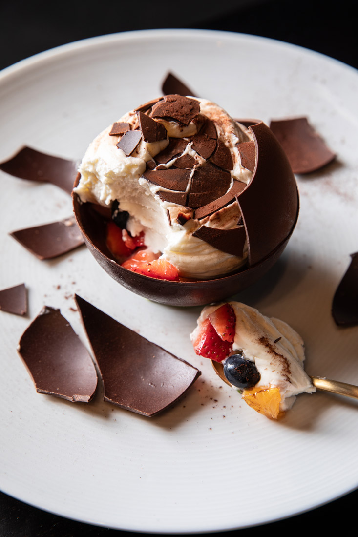 Use the provided mallet to crack open Umi's chocolate Kyu sphere to reveal cream and berries inside.
