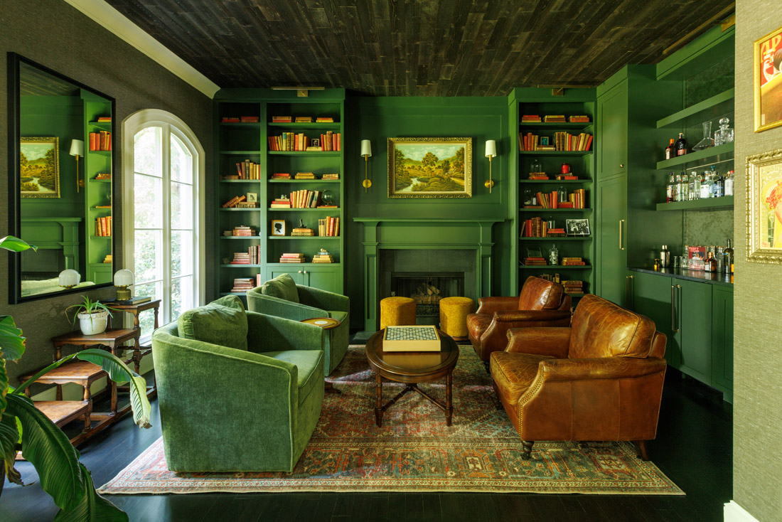 The library is color drenched in Sherwin-Williams Laurel Woods, making a remarkable statement in the otherwise minimal Miller home.