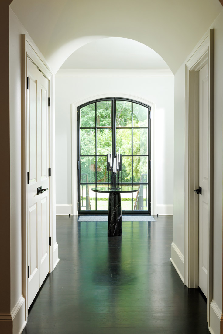Dark flooring mimics the home's hardware and window mullions.
